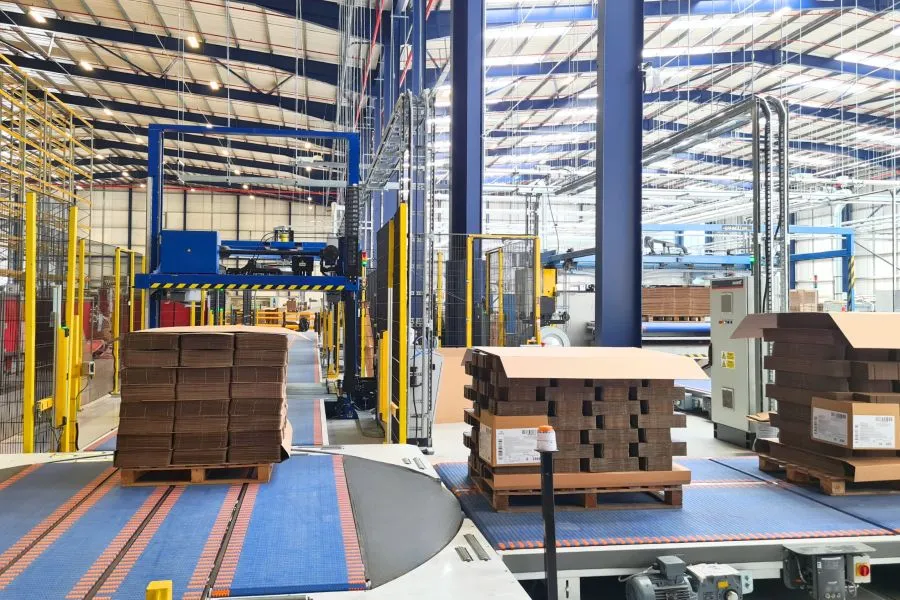 A warehouse with pallets on conveyor belt.